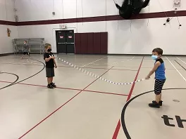 Two boys play jump rope.
