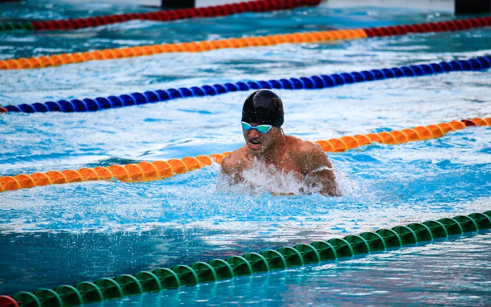 Man coming up for air during a swim race.