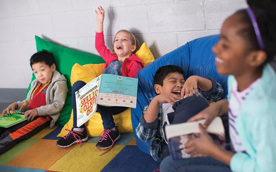 Kids laughing and reading books