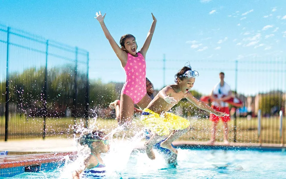 Children playing in an outdoor pool