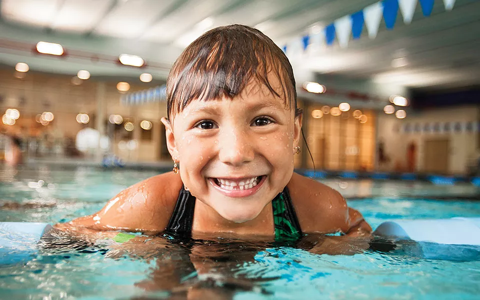 Young girl is swimming pool.