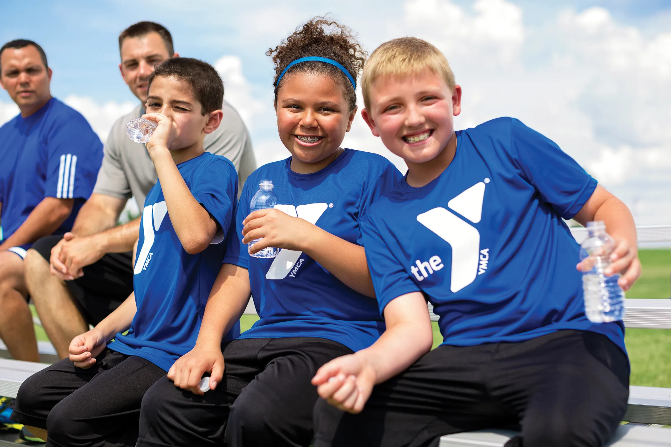 YMCA sports teammates having fun on the bench.